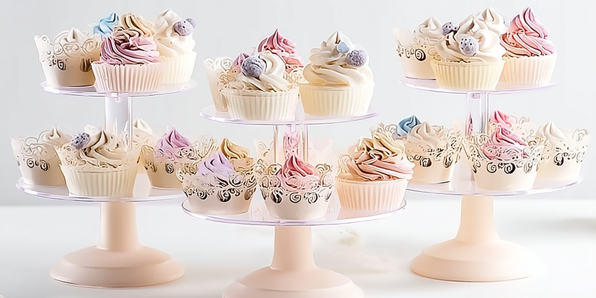 Cupcakes décorés aux couleurs pastel présentés sur des présentoirs à gâteaux